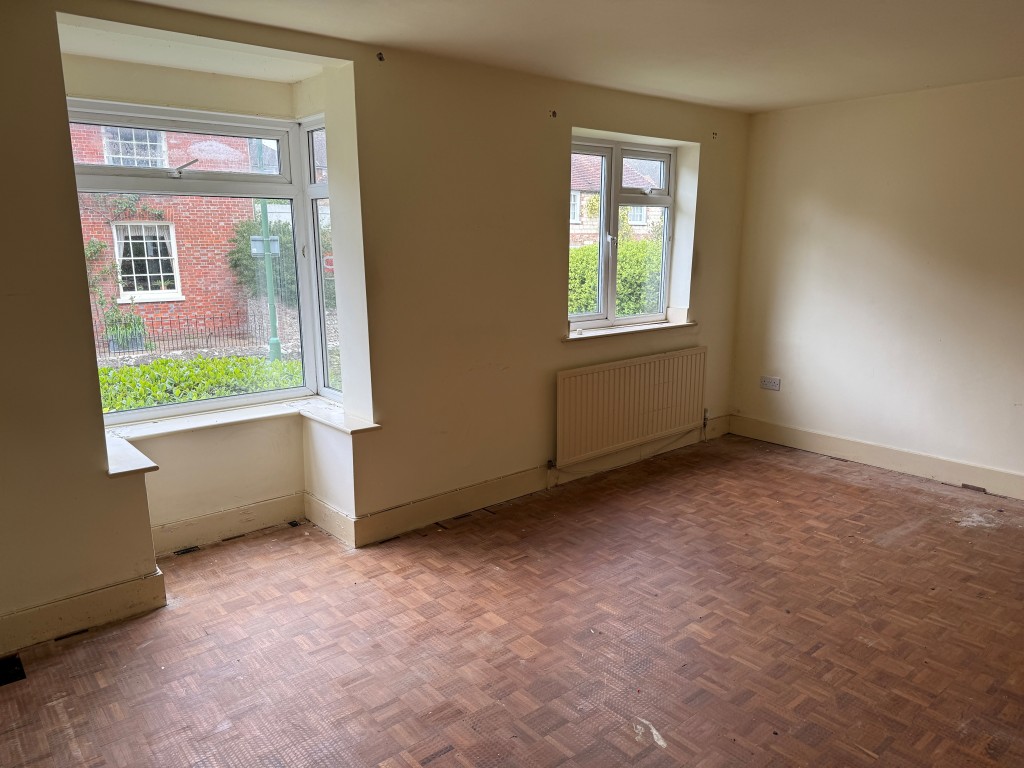 Lot: 88 - GROUND FLOOR FLAT WITH GARAGE IN NEED OF UPDATING - Front living room with two windows